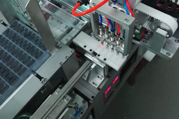 Machine automatique de mise en plateaux de modules USB encapsulés